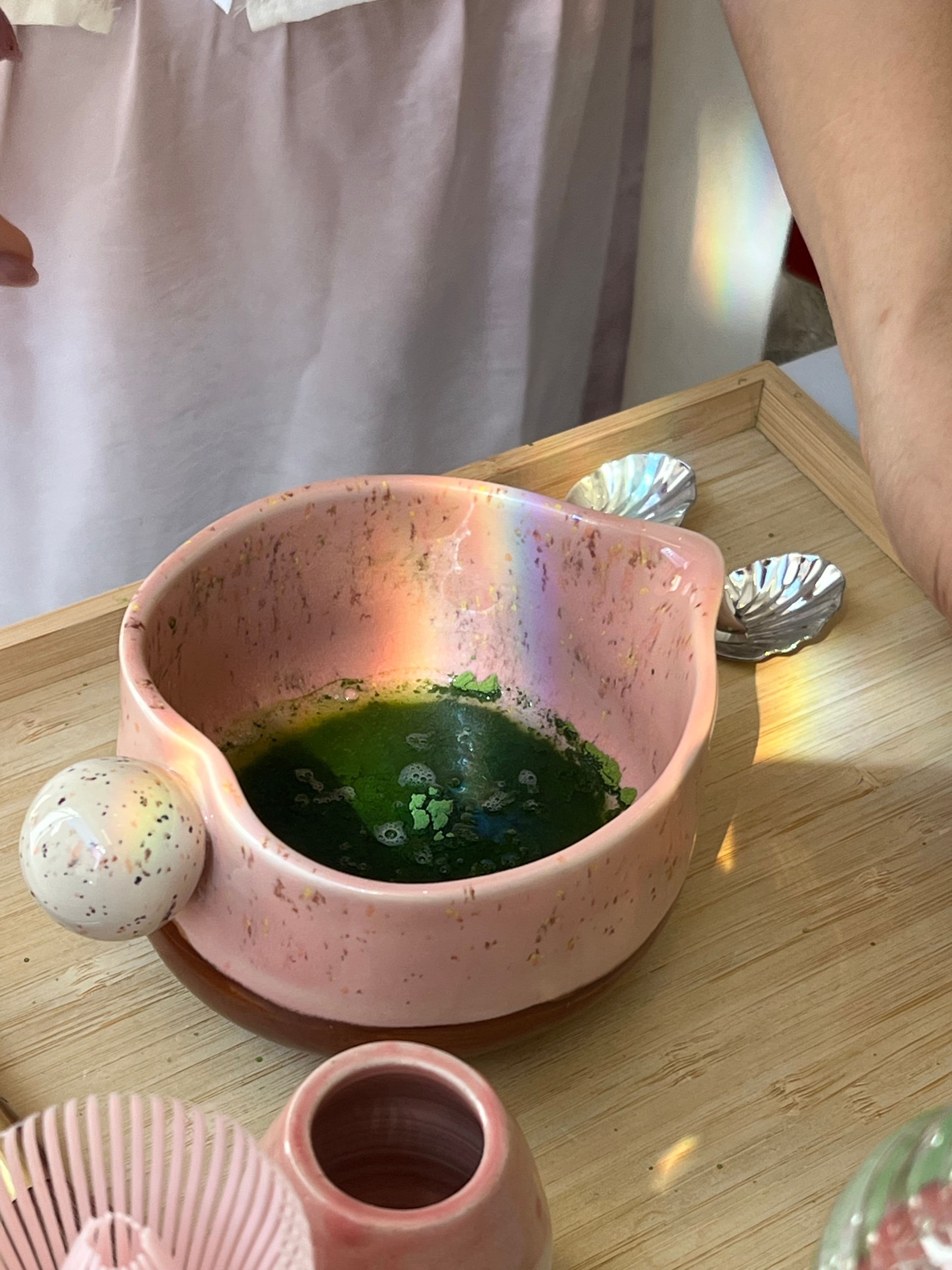 Ceramic bowls and tea ware arranged on a wooden table